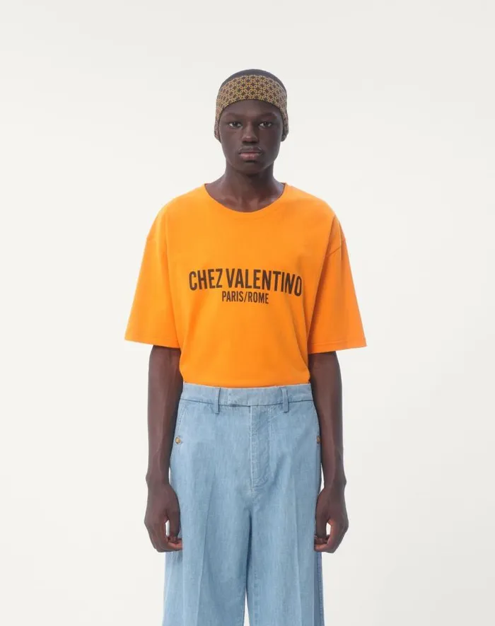Valentino Tshirts And Sweatshirts Man Cotton Tshirt With Chez Valentino Print For Man In Orange Orange Valentino Tshirts And Sweatshirts Man Cotton Tshirt With Chez Valentino Print For Man In Orange Orange